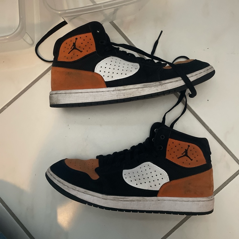 Jumpman air Jordan “access shattered backbone” black and orange